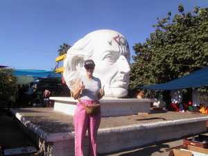 Nadine in front of a statue of Benito Juarez at the Juarez market